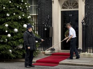 A Downing Street employee sweeps the red carpet beside a police officer ahead of a visit by Britain's Queen Elizabeth II outside No 10 Downing Street in London December 18, 2012. Queen Elizabeth II attended a British Cabinet meeting on December 18, the first such visit in more than a century. Historically, monarchs used to chair Cabinet meetings but the last one to exercise their right to attend was queen Victoria, Queen Elizabeth's great-great grandmother, who died in 1901. The 86-year-old sovereign is going to the prime minister's Downing Street residence to receive a diamond jubilee gift from the Cabinet, marking her 60 years on the throne, and will also sit in on their meeting as an observer. AFP PHOTO / ADRIAN DENNISADRIAN DENNIS/AFP/Getty Images